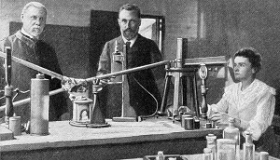 ilustracja marii curie-sklodowskiej z mezem w laboratorium